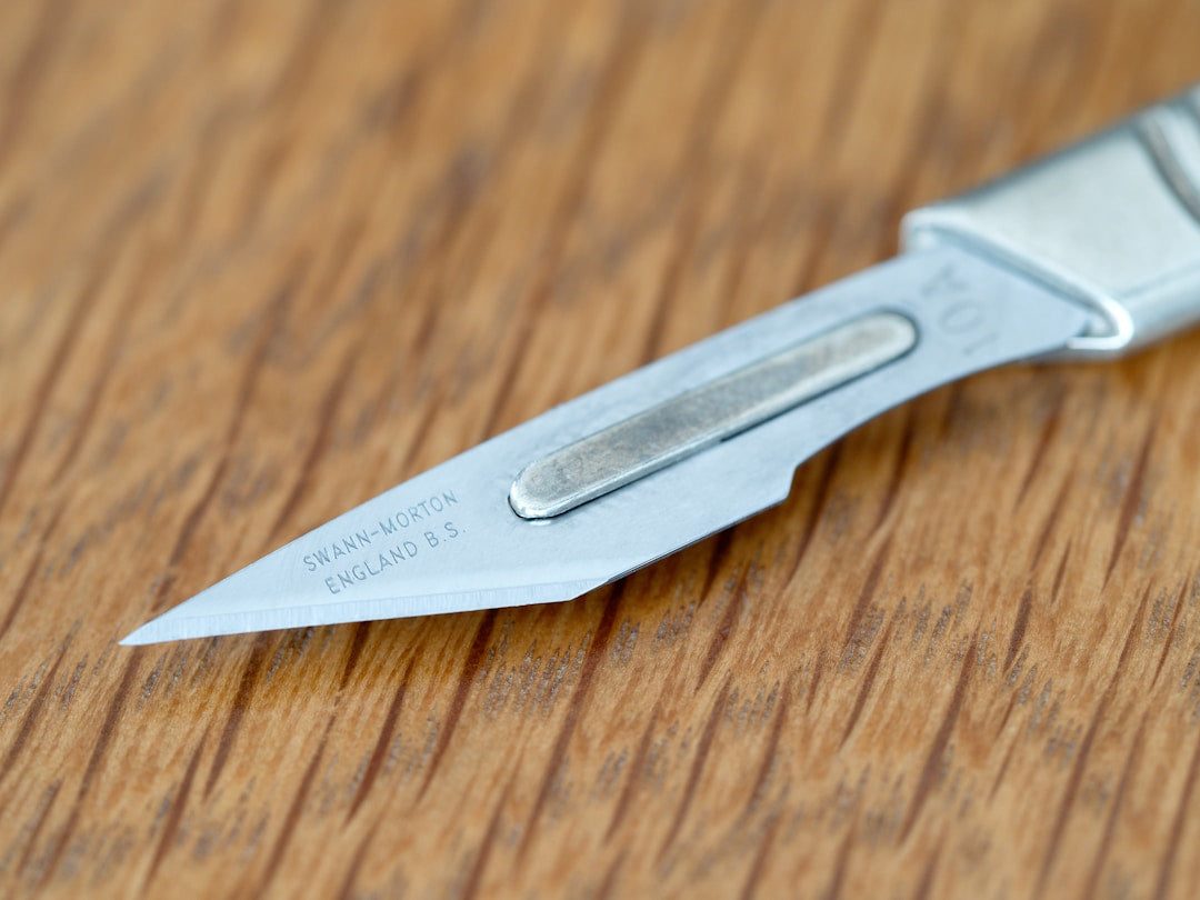 Knife blade on whetstone for repair