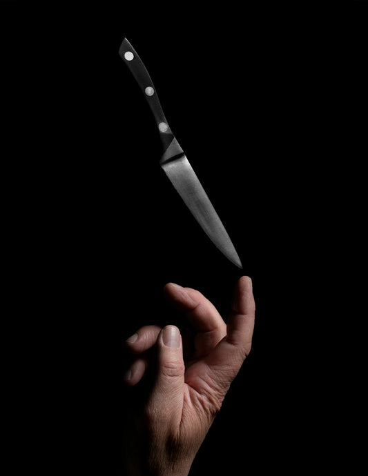 Close-up of hands demonstrating proper knife grip